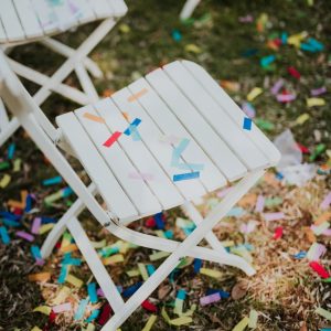 Confetti on white chairs after wedding party