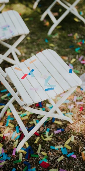 Confetti on white chairs after wedding party